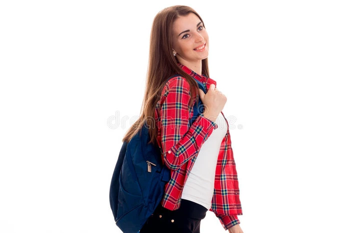 兴高采烈的年轻女学生背着书包面带微笑独自站在白色背景上学生年概念
