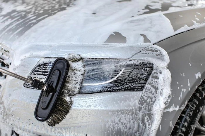 汽车清洁在用手的洗车房刷子离开中风采用洗发剂英语字母表的第15个字母