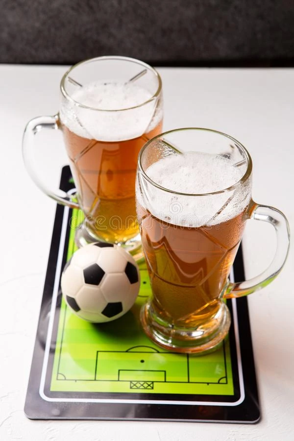 照片向顶关于两个脸关于起泡的啤酒,表足球,球