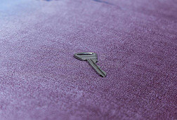铁器钥匙从房间寓所放置向紫色的地毯透镜波黑